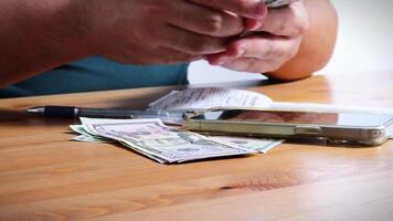 Male Hands Counting a Stack of 100 Dollar Bills on Blurred Money Background. Stack of banknotes in 10000 american dollars currency strap for hundreds. Investments in cryptocurrency. Capital. Wealth. video
