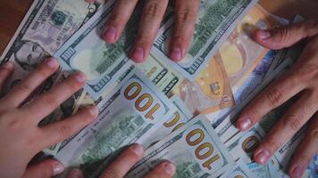Male Hands Counting a Stack of 100 Dollar Bills on Blurred Money Background. Stack of banknotes in 10000 american dollars currency strap for hundreds. Investments in cryptocurrency. Capital. Wealth. video