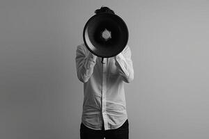 Neutral web banner concept featuring person with a megaphone against a plain grey background photo