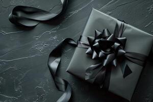Black Gift Box with Ribbon on Dark Backdrop Top View Minimalistic Concept photo