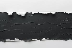 Ripped black paper in flat lay arrangement on clean white background. Torn banner concept photo