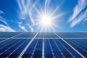 A close up of a solar panel with the sun shining photo