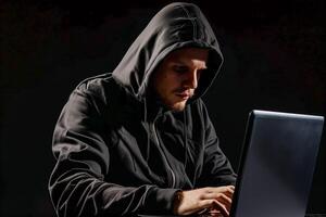 Man in a hoodie using a laptop computer photo