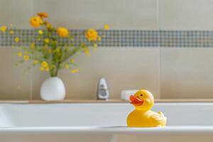A yellow rubber duck in bathtub photo