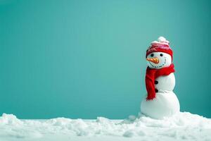 A snowman with a red scarf and a hat on photo