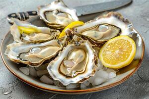 Several oysters on a plate with lemon slices photo