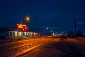 Neon-lit motel at night beside a road photo