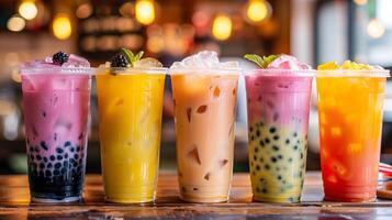A row of various fresh bubble beverages on a table photo