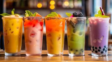 Different drinks lined up on a table photo
