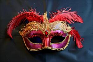 Masquerade mask adorned with crimson plumes and gilded details on ebony backdrop photo