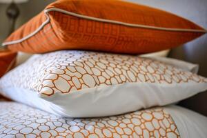 Three pillows stacked on a bed photo
