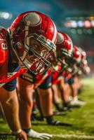 Football players lined up on the field ready to play photo