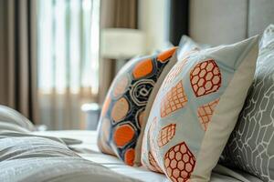 Two pillows on the bed with blue and orange pillow photo