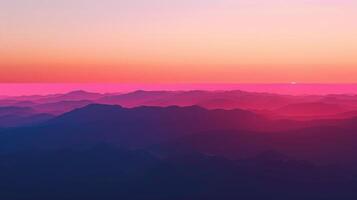 Stunning Pink and Purple Mountain Range at Sunset With Hazy Horizon and Dramatic Sky photo