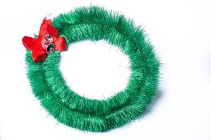 Green Christmas wreath with red bow isolated on white background. Christmas concept. photo