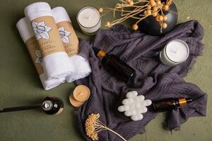 Spa Essentials Flat Lay with Amber Bottles, Candles, Towels, and Dried Flowers photo