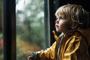 Lonely girl watching raindrops on the window with a sad expression, longing for warmth photo