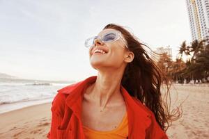 Smiling Woman in Colorful Sunglasses, Embracing the Freedom of the Sea. A Vibrant Portrait of a photo