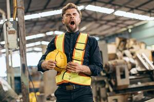 lazy sleepy yawning engineer industry worker tired fatigue from hard work and sleep late or sleepless worn out at workplace photo