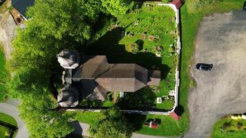 Aerial asceding top down view of church in village in Sumava Czechia video