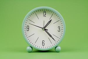 Time, standing still, time hand, photo of a moving clock on a green background, time concept.