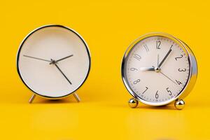 Time and work, the clock stops, the minute hand stops moving, a photo of a clock on a yellow background.