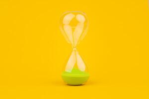 Hourglass on yellow background, time and countdown time limit for urgent work to meet deadlines and appointments. photo
