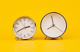 Time and work, the clock stops, the minute hand stops moving, a photo of a clock on a yellow background.