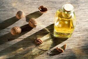 Walnuts and a bottle of walnut oil photo