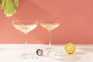 ocktail with a lemon with beautiful shadows and highlights on a white background and palm leaves. Vertical banner with a copy space for your text photo