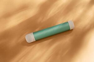 mint stick - disposable vaping device, electronic cigarette on a beige background. Flat lay, top view, minimal design with shadows of sunlight. photo
