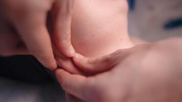 close up of unrecognizable female hands of masseur giving therapeutic neck massage to woman lying on massage couch in massage spa center video