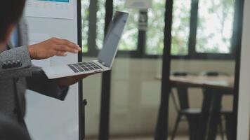 Financial analysts analyze business financial reports on a digital tablet planning investment project during a discussion at a meeting of corporate showing the results of their successful teamwork. video