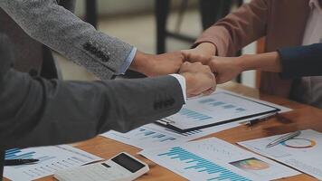 Financial analysts analyze business financial reports on a digital tablet planning investment project during a discussion at a meeting of corporate showing the results of their successful teamwork. video