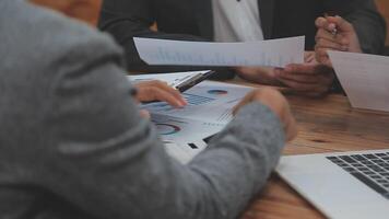 Financial analysts analyze business financial reports on a digital tablet planning investment project during a discussion at a meeting of corporate showing the results of their successful teamwork. video