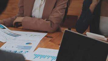 Financial analysts analyze business financial reports on a digital tablet planning investment project during a discussion at a meeting of corporate showing the results of their successful teamwork. video