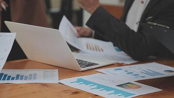 Financial analysts analyze business financial reports on a digital tablet planning investment project during a discussion at a meeting of corporate showing the results of their successful teamwork. video