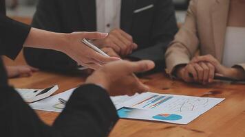 Financial analysts analyze business financial reports on a digital tablet planning investment project during a discussion at a meeting of corporate showing the results of their successful teamwork. video