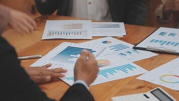 Financial analysts analyze business financial reports on a digital tablet planning investment project during a discussion at a meeting of corporate showing the results of their successful teamwork. video