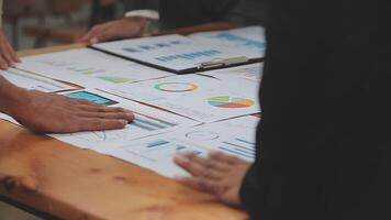 Financial analysts analyze business financial reports on a digital tablet planning investment project during a discussion at a meeting of corporate showing the results of their successful teamwork. video
