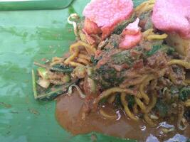 Lotek, traditional indonesian salad. Made from various kind of steamed vegetable mixed with spicy peanut sauce and crackers. photo