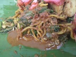 Lotek, traditional indonesian salad. Made from various kind of steamed vegetable mixed with spicy peanut sauce and crackers. photo