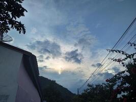 Looking straight up at the the sky. Thin clouds pattern with blue sky as background photo