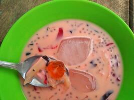 Ice jelly drink is a fresh drink made from pieces of jelly mixed with sweetened condensed milk and sugar water, then served with ice cubes photo