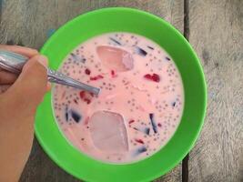 Ice jelly drink is a fresh drink made from pieces of jelly mixed with sweetened condensed milk and sugar water, then served with ice cubes photo