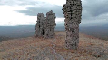 Top view of stone pillars on mountain. Clip. Natural stone pillars on mountain on cloudy day. Landscape with mysterious stone pillars on mountain video