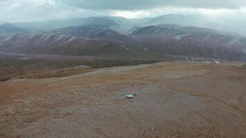 Mountains. Clip. An empty area of brown mountains as if in a desert against the background of the same misty sky. video