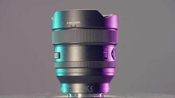 UK, LONDON - MARCH 21, 2022. Large wide angle lens. ACTION. Showing a new lens on a purple background. Large zoom lens for SLR camera video
