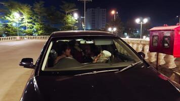 Parked car at night with couple inside video
