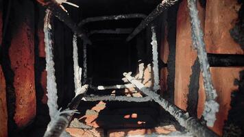 Closer view of a dark hole between steel bars and bricks photo